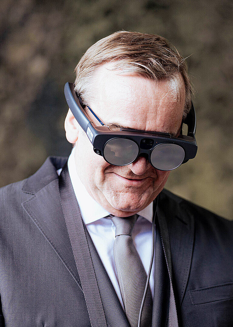 Verteidigungsminister Pistorius trägt Mixed-Reality-Brille und schaut nach unten